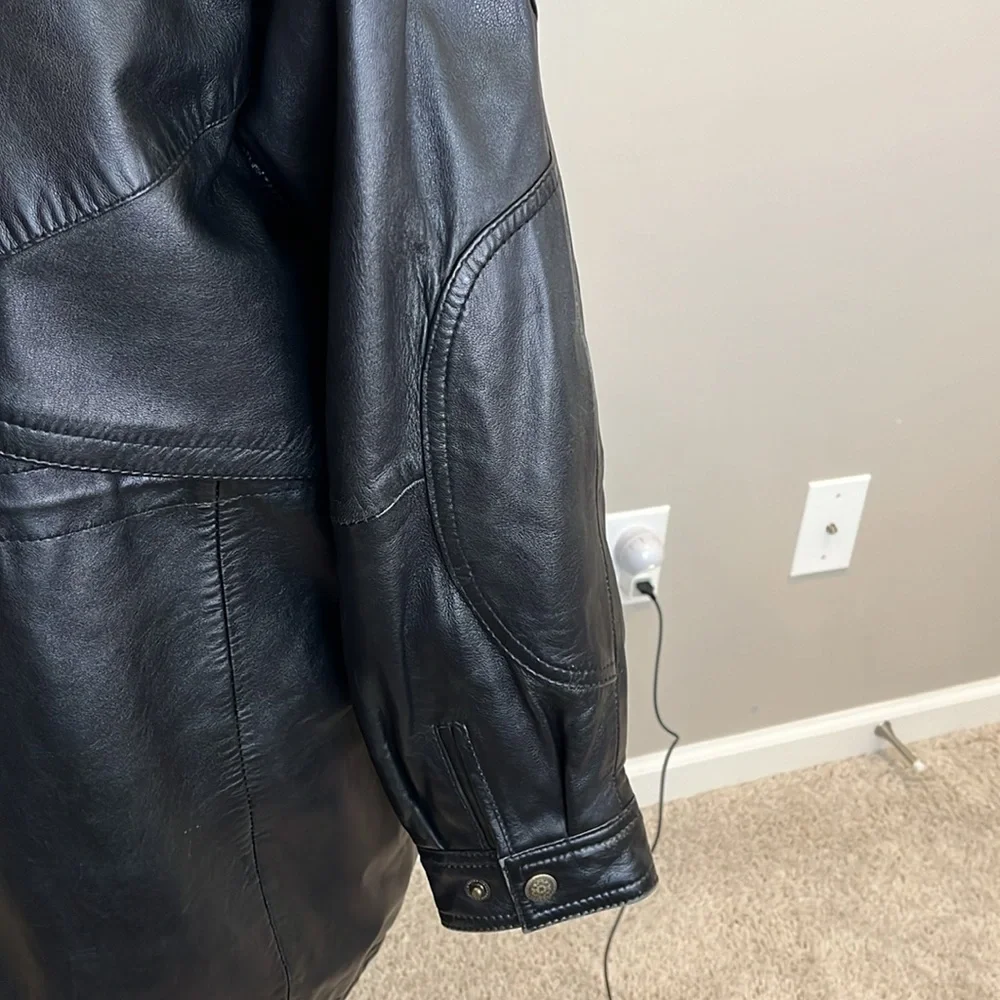 Vintage men’s SZ sm black leather coat w/fur trim hood.  Hits below the hips.
